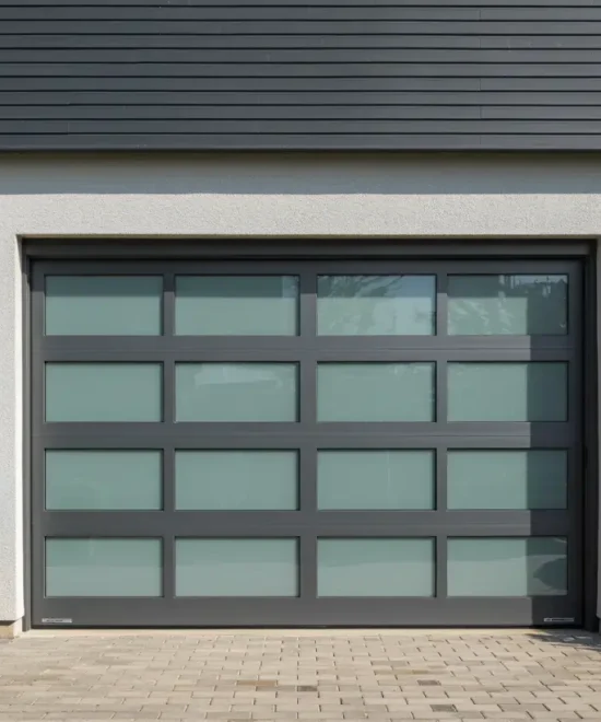 Full-view garage door with sixteen frosted glass panels in a dark gray aluminum frame on a stucco wall