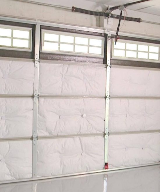 Insulation panels installed inside a sectional garage door