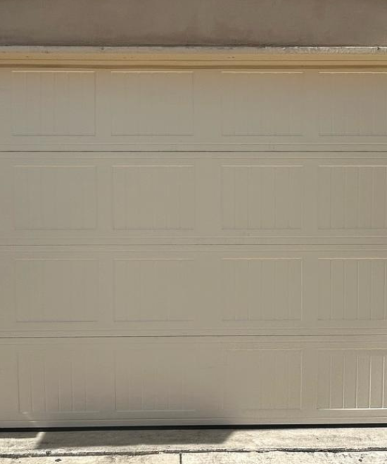 Newly installed cream panel double garage door