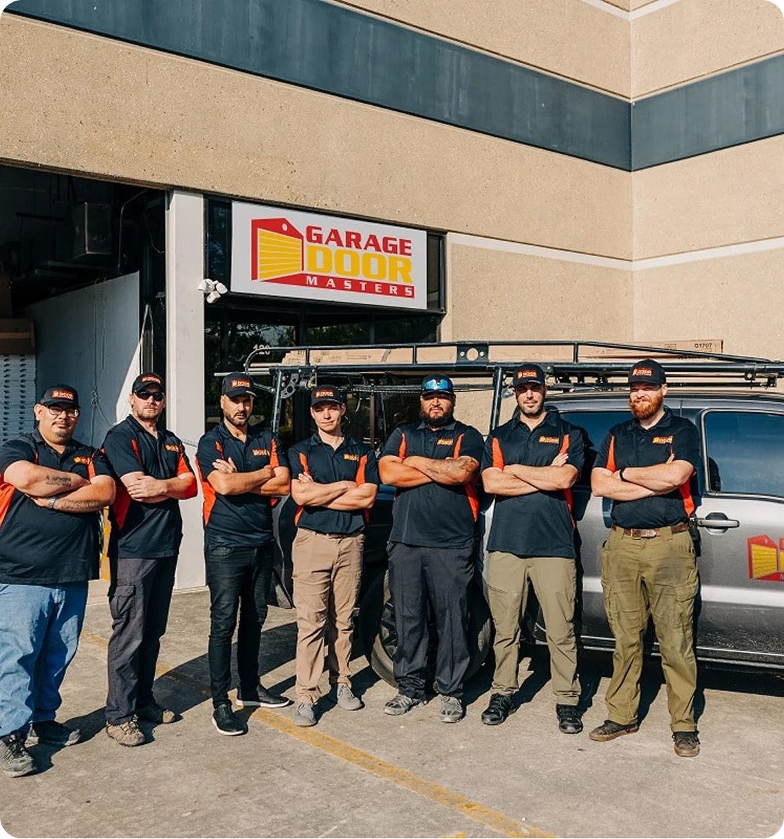 Garage Door Masters team outside their San Antonio shop