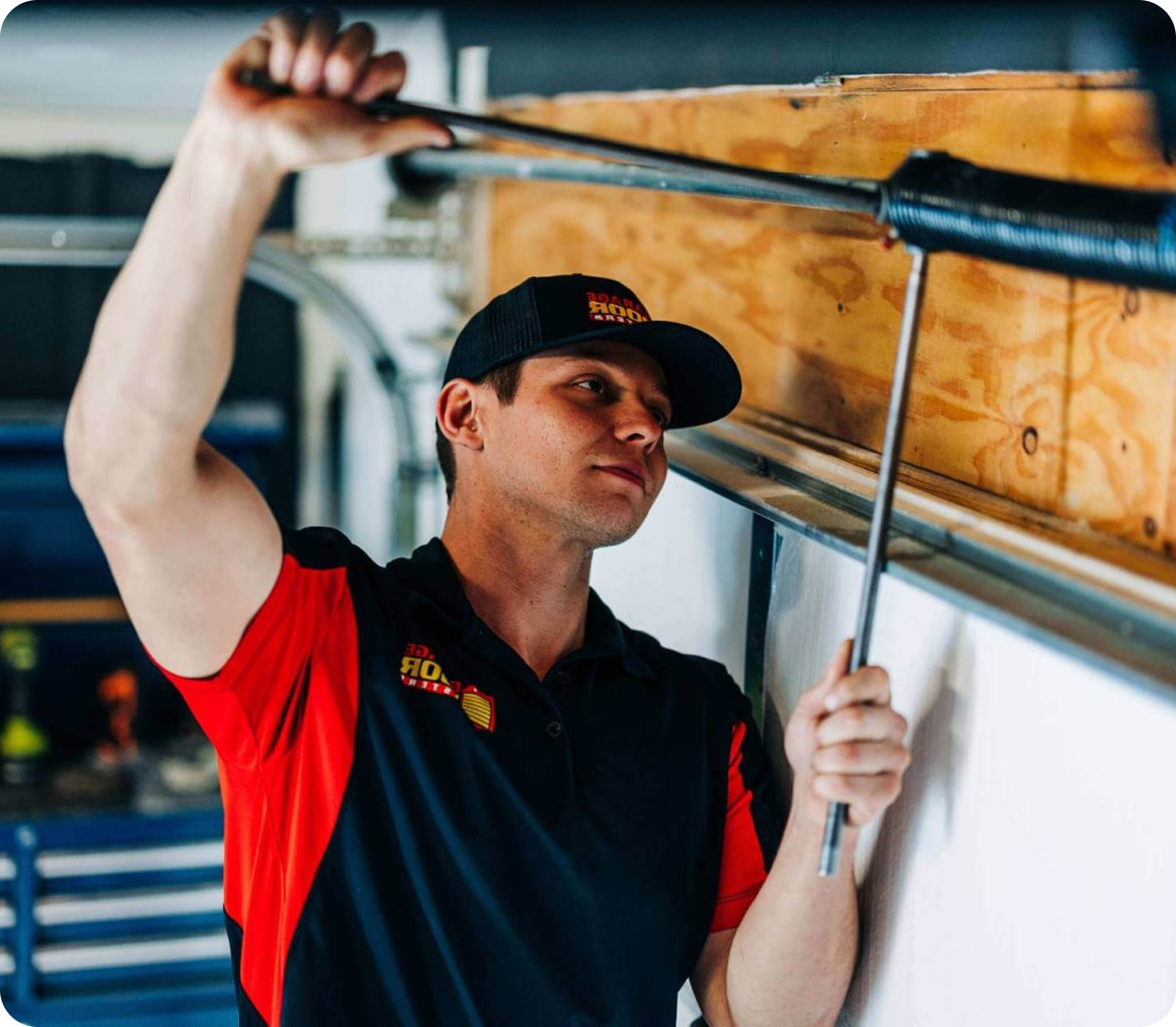 Technician adjusting a garage door track