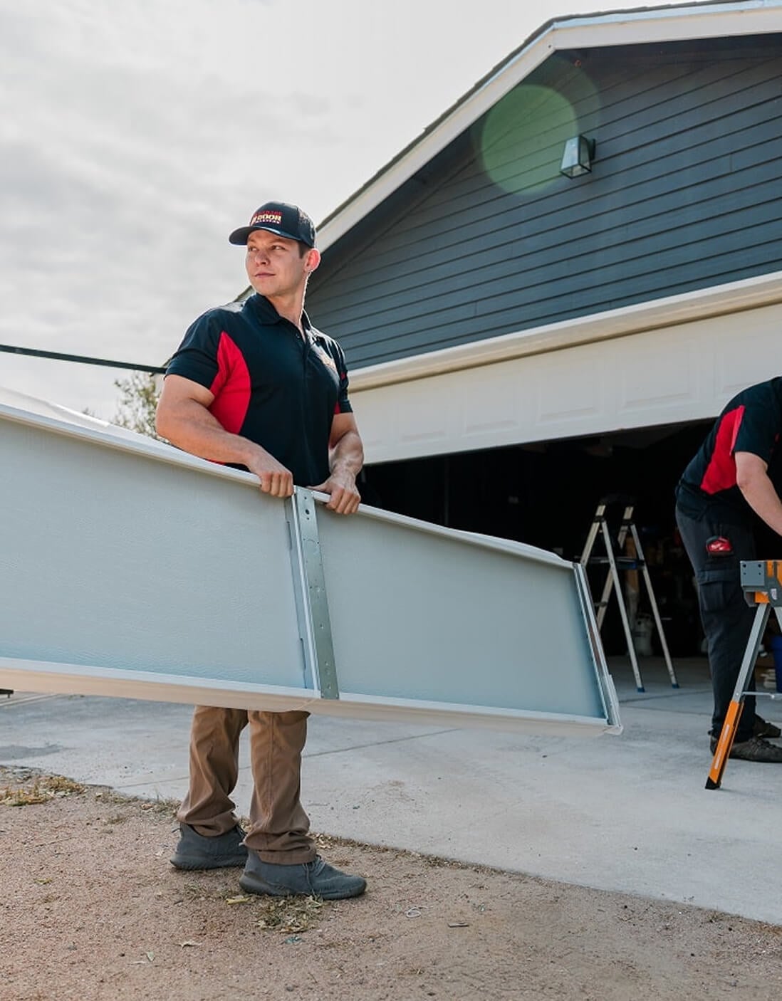 Technician carrying a garage door section