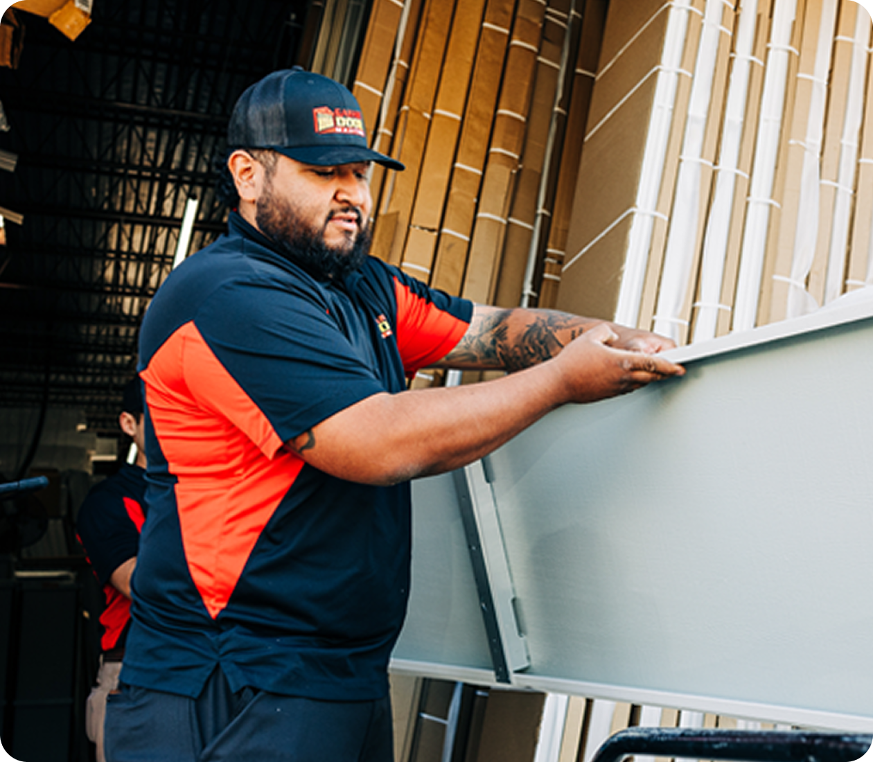 Technician fitting a new garage door panel