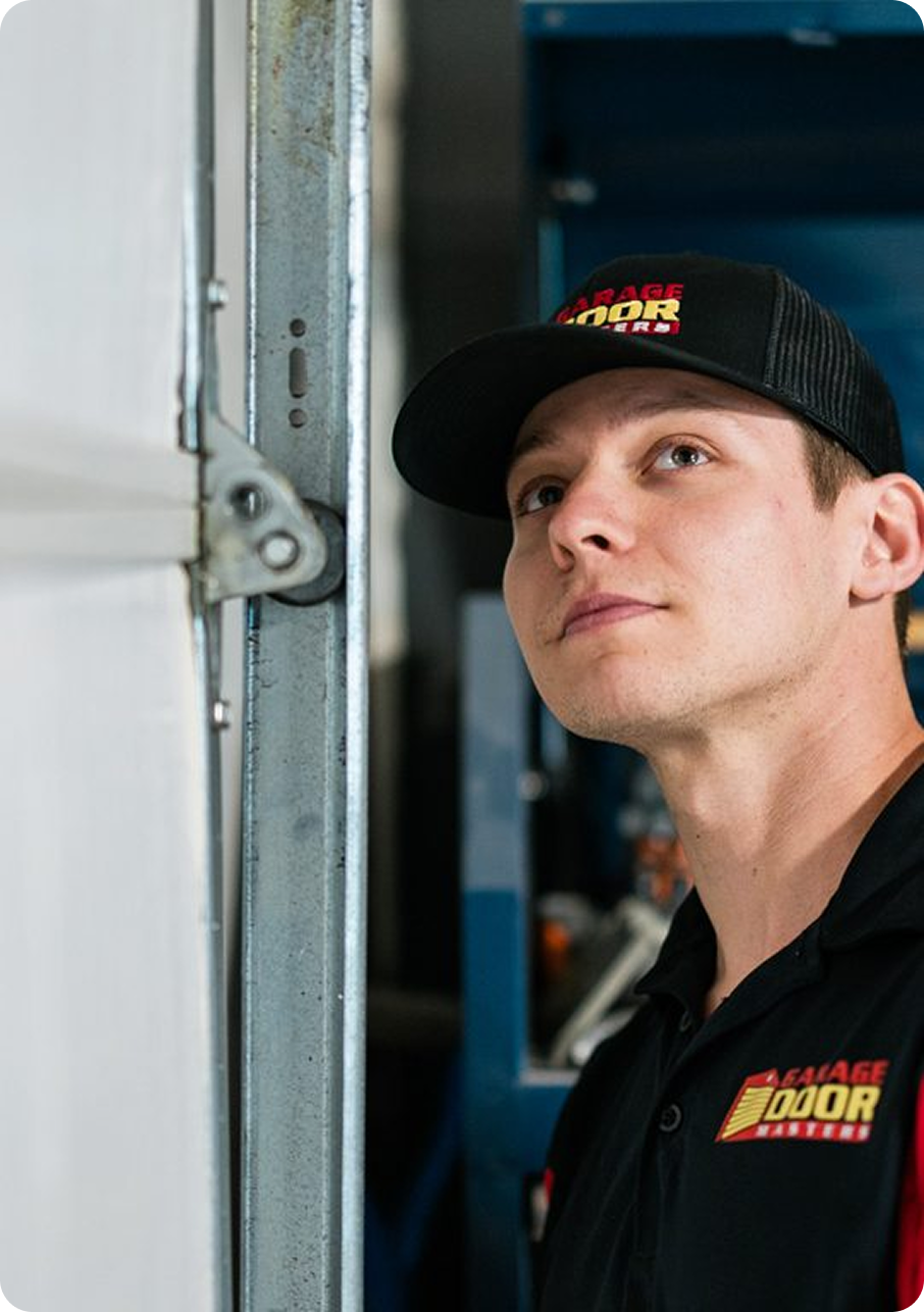 Garage Door Masters technician inspecting a garage door