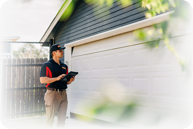 Technician inspecting a residential garage door