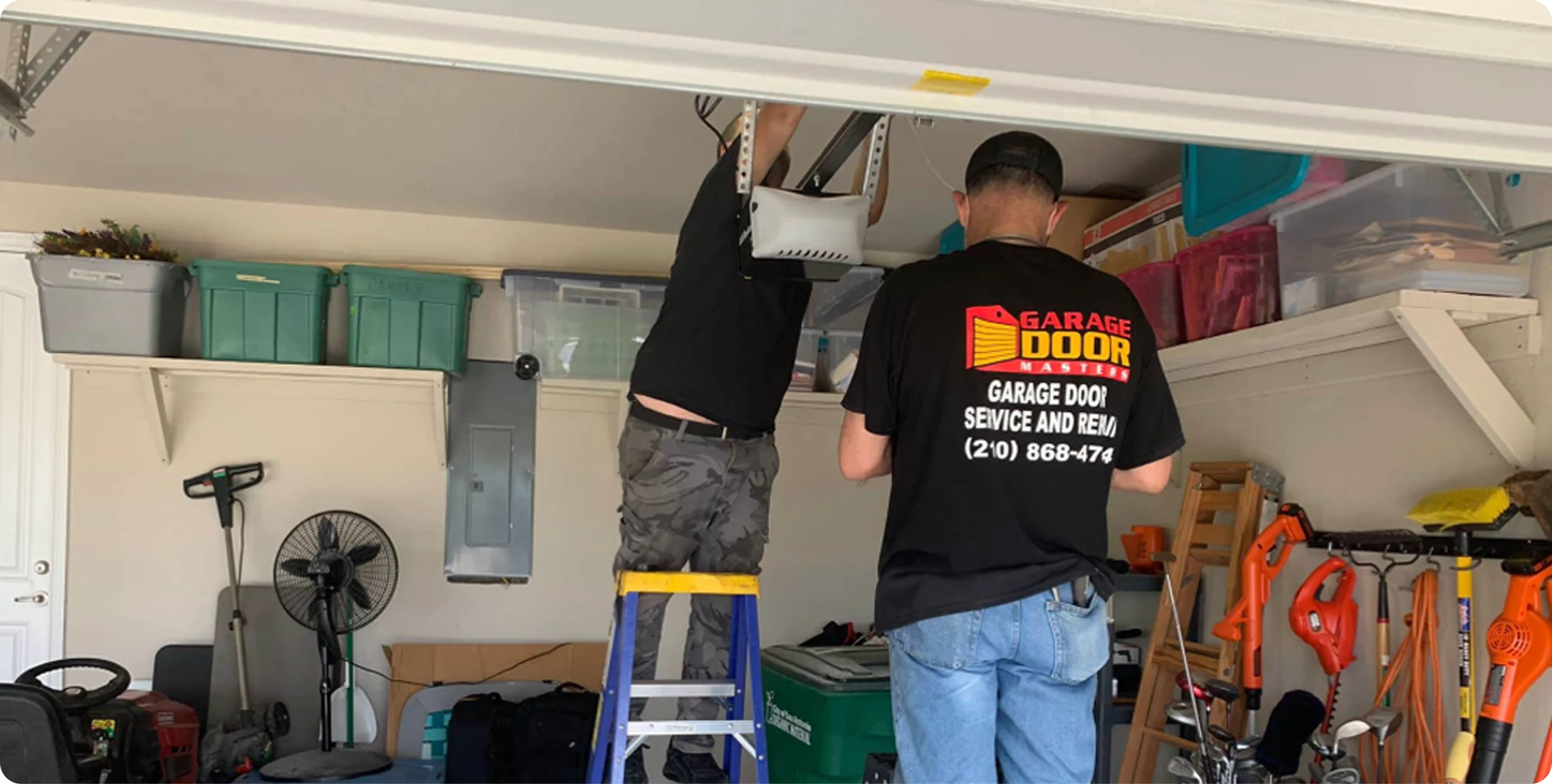 Garage Door Masters technician installing a garage door opener