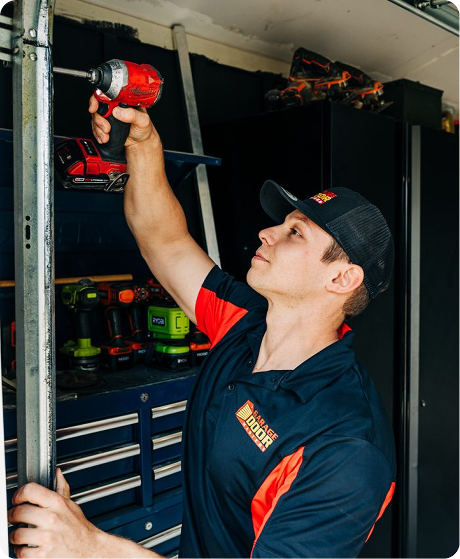 Technician repairing a garage door track