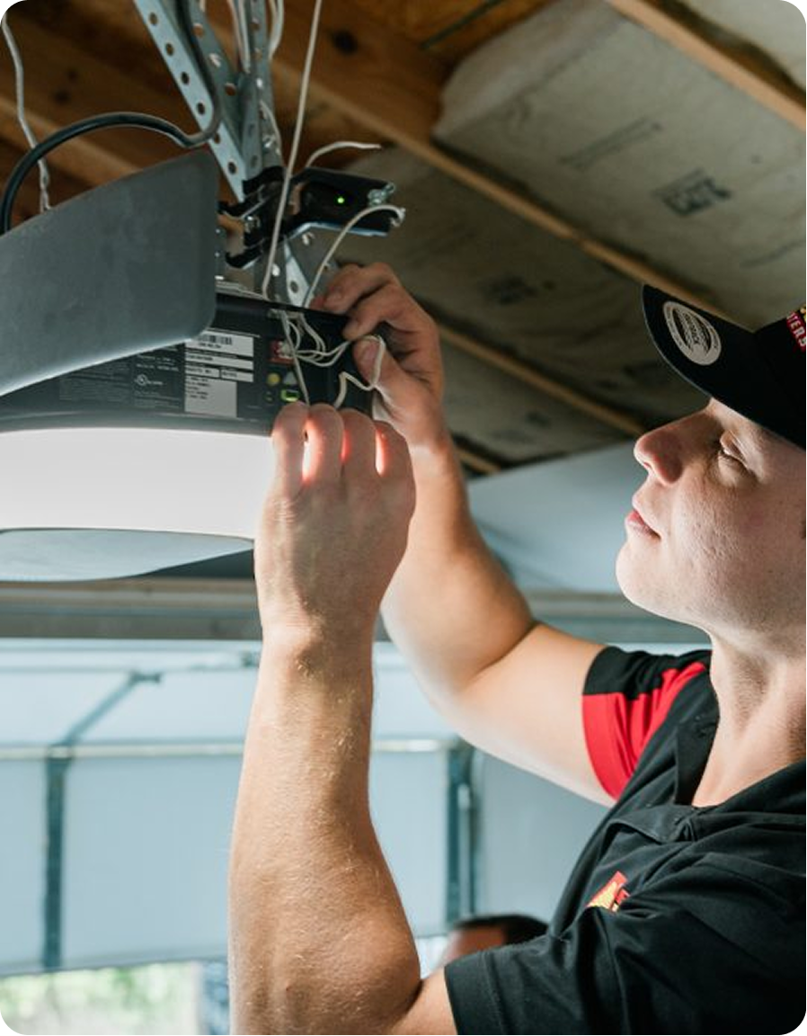 Technician servicing a garage door opener